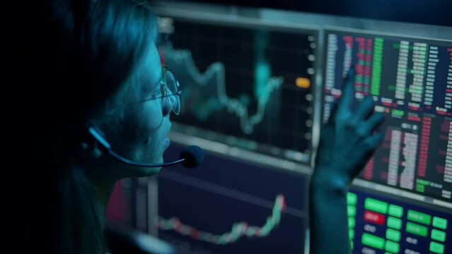 Trader is working with multiple computer screens with charts and data analysis and stock broker trading online. Concept of bitcoin and ethereum blockchain trading. Worker is checking market data