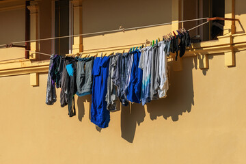 Old clothes drying on the rope between two windows of an old istrian house