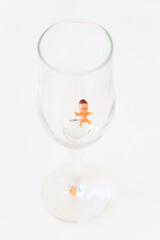 The baby is drowning at the bottom of the glass. Alcoholism leads to infertility.