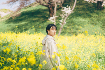 Portrait beautiful japanese woman short hair relax in spring nature with sakura tree
