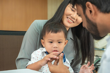 pediatrician hold stethoscope exam child boy patient with mother, black pediatrician seduce by toy kid pediatric checkup in hospital children medical care