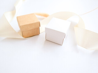 Small craft boxes for packing jewelry on a white holiday background. The concept of packaging, holiday, gifts. Place for text and logo.
