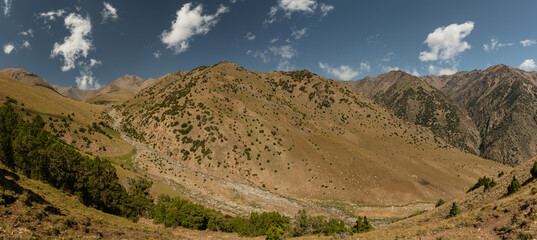Panoramic view of wild mountain landscape in Turkestan Mountains in Kyrgyzstan.