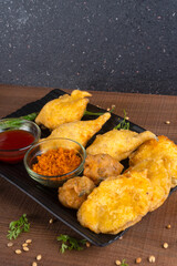 Indian Tea time snacks in group includes Veg Samosa, Kachori/kachaudi, aloo bonda, khaman dhokla, bread, onion,chilli and moong pakora/pakoda/bhaji/bhajji/Bhajiya/bajji with sauces, selective focus
