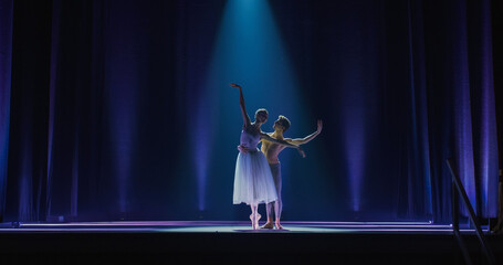 Cinematic Wide Shot of the Stage: Two Young Classical Ballet Dancers Performing in Theatre....
