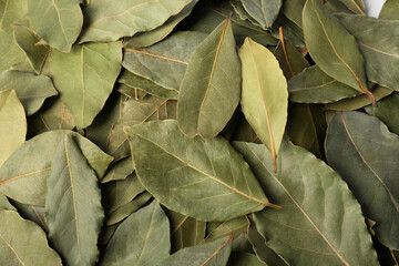 Pile of aromatic bay leaves as background, top view