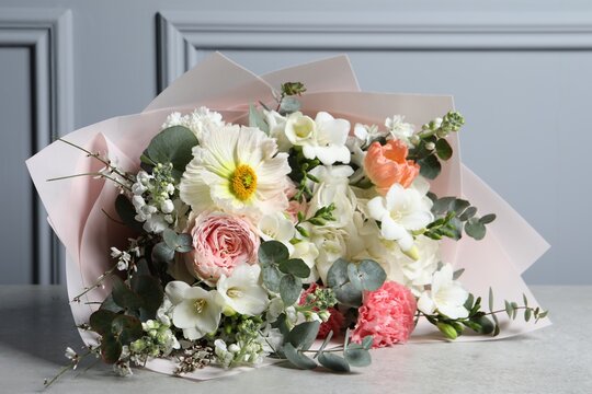 Bouquet of beautiful flowers on light grey table