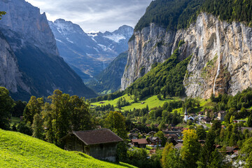 Lauterbrunnen valley elevated scenic view in switzerland with waterfall and dark clouds in late summer