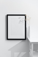 Blank wooden frame mockup on white wall with copy space, portrait black frame mock up