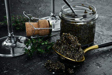 Beluga black caviar and toast bread. Preparation of luxury snacks. On a concrete background. - obrazy, fototapety, plakaty