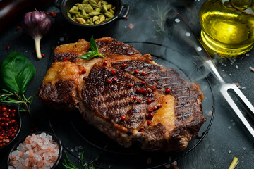 Juicy Grilled ribeye beef steak. At the aged table. Side view. Free space for your text.