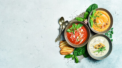 Dietary cream soups from vegetables. Colored soups in a bowl. Healthy food concept. Advertising photo.