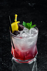 Cocktail with blackberry liqueur and lemon peel in a glass. Bar menu.