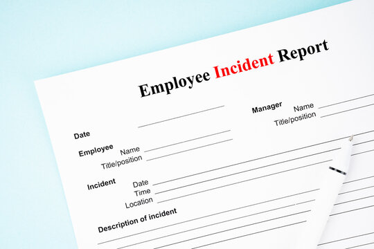 The Template of an Employee incident report form document and and pen on blue background.