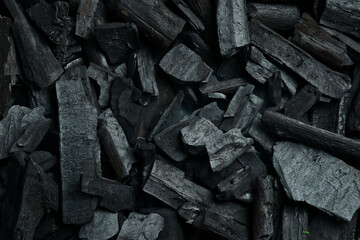Black charcoal texture background. Close-up. Space for text.