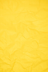The Vertical yellow color creased paper texture as background.