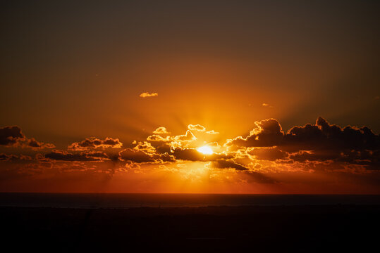 The stunning sunrise over Sibari and the Adriatic Sea offers a picturesque view of the coastal town's natural beauty. The warm glow of the sun, rising above the horizon, creating a serene atmosphere