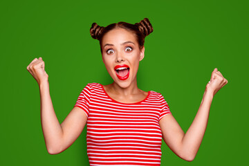 Young excited woman happy and screamings, celebrate the win raise both fists up isolated on red background. Joy fun concept
