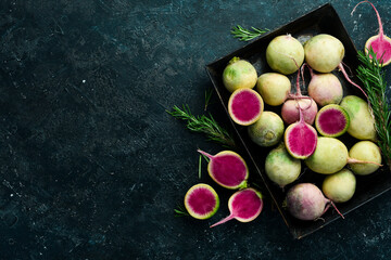 Useful vegetables. Radish watermelon on a metal tray, diet food. Free space for text, on stone background.