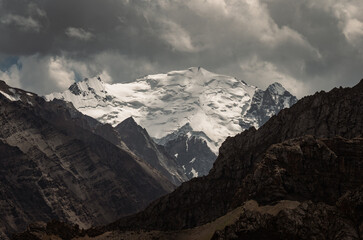 Glaciers on the massive mountain peaks of the Turkestan Ridge. In Kyrgyzstan. Above the Orta-Chashma river valley.