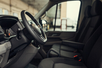 Obraz na płótnie Canvas Minivan driver seat inside modern cargo van