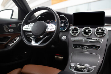 Modern luxury interior of car with leather seats big multimedia monitor dashboard and control panel...