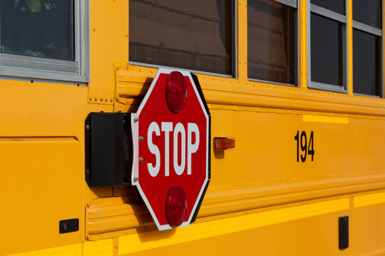 Stop road sign at the school bus