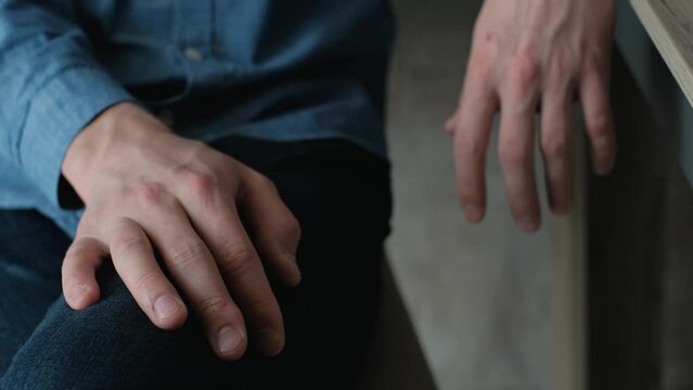 Male hands with parkinson's syndrome close-up. Man's hands tremble with fear