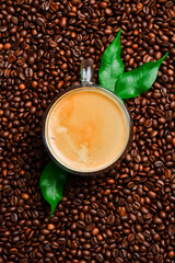 A cup of hot espresso coffee on the table with coffee beans. Free space for text. Promotional photo