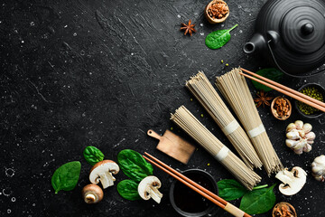 Raw soba noodles on a gray stone background. Japanese noodles. Top view.