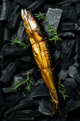 Smoked mackerel fish on hot coals. Barbecue. Cooking fish. Charcoal.