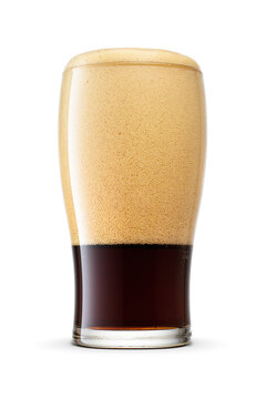 Tulip pint glass of dark stout beer with with huge cap cap of foam isolated on white background.