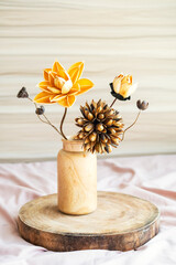 Dried flowers bouquet in wooden vase on tray. Interior details still life.