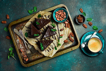 Coffee and chocolate brownie. On a metal tray. Sweets Top view.