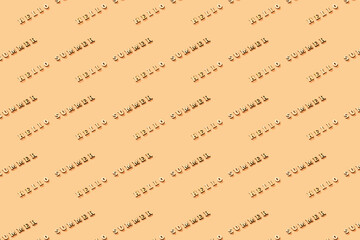Fototapeta premium Text of wooden letters Hello summer on yellow background. Summer time concept. New season. Summer greeting. Pattern.