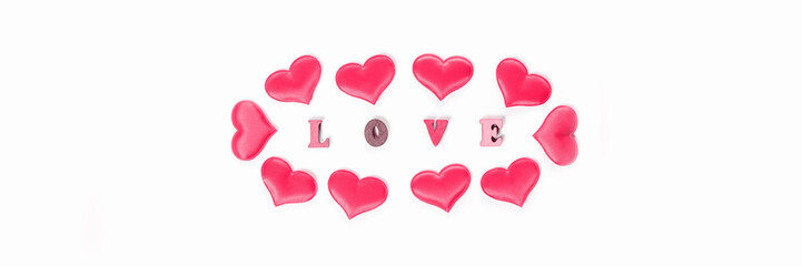 Inscription love made of wooden letters with hearts for Valentines Day. Festive hearts for declaration of love and strong relationship. Banner.