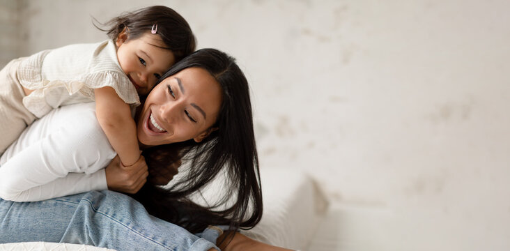 Asian Baby Daughter Hugging Mom Cuddling Having Fun At Home