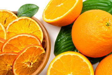 Dry orange slices and fresh fruits on white background. Dehydrated snacks of orange fruits. Healthy, no sugar sweet food. Candied citrus fruit
