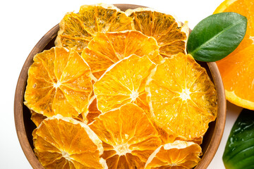 Dry orange slices and fresh fruits on white background. Dehydrated snacks of orange fruits. Healthy, no sugar sweet food. Candied citrus fruit