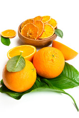 Dry orange slices and fresh fruits on white background. Dehydrated snacks of orange fruits. Healthy, no sugar sweet food. Candied citrus fruit