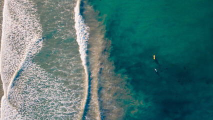 Waves with Surfers by the ocean in california coast manhattan beach