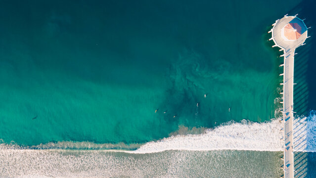 Waves with Surfers by the ocean in california coast manhattan beach