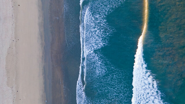 Waves with Surfers by the ocean in california coast manhattan beach