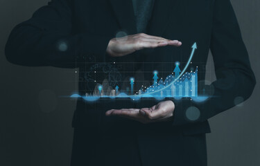 Business invest growth success concept. Man in black suit show hologram technology graph, chart, diagram on hands. Stock and trade. Sales forecasting to analysis profit and loss of the company