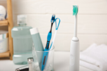 Modern sonic or electric toothbrush with charger in the bathroom. The concept of professional oral...