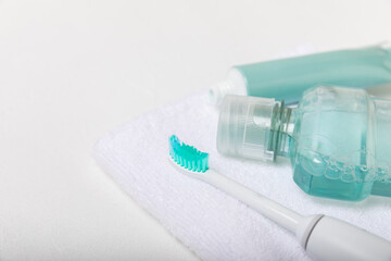 Modern sonic or electric toothbrush with charger in the bathroom. The concept of professional oral care and healthy teeth. Place for text. Close-up. Minimal design. Fresh breath. Healthy teeth.