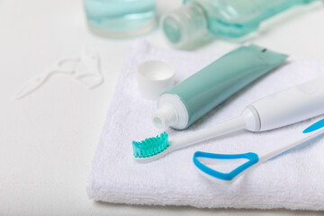 Modern sonic or electric toothbrush with charger in the bathroom. The concept of professional oral care and healthy teeth. Place for text. Close-up. Minimal design. Fresh breath. Healthy teeth.