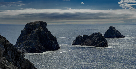 Cliffs And Sail Boat At Pointe De Penhir At The Finistere Atlantic Coast in Brittany, France