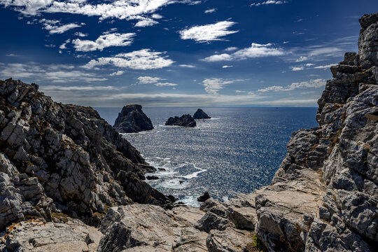 Cliffs And Sail Boat At Pointe De Penhir At The Finistere Atlantic Coast in Brittany, France