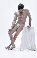 Full-length portrait of handsome man with muscular relief body posing shirtless in underwear...